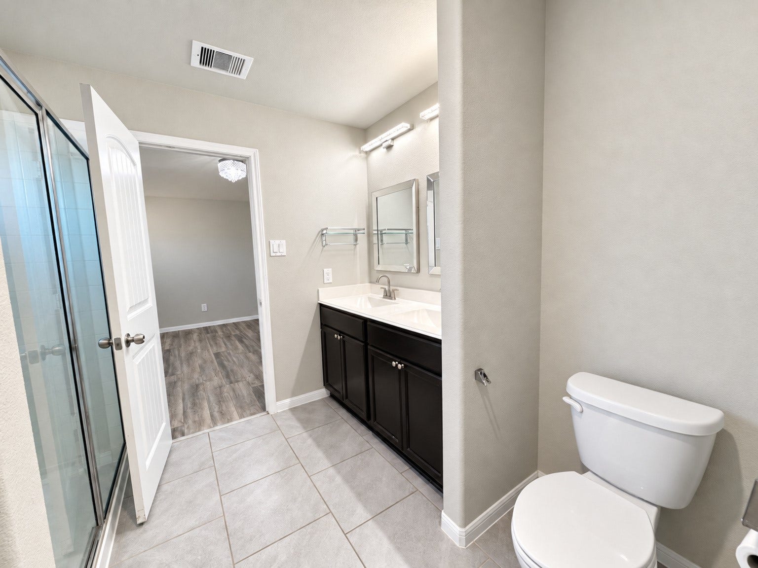 29202 Dunns Creek Court, Katy, TX 77494 Alternate primary bathroom view showing the vanity, glass-enclosed shower, and adjoining bedroom.