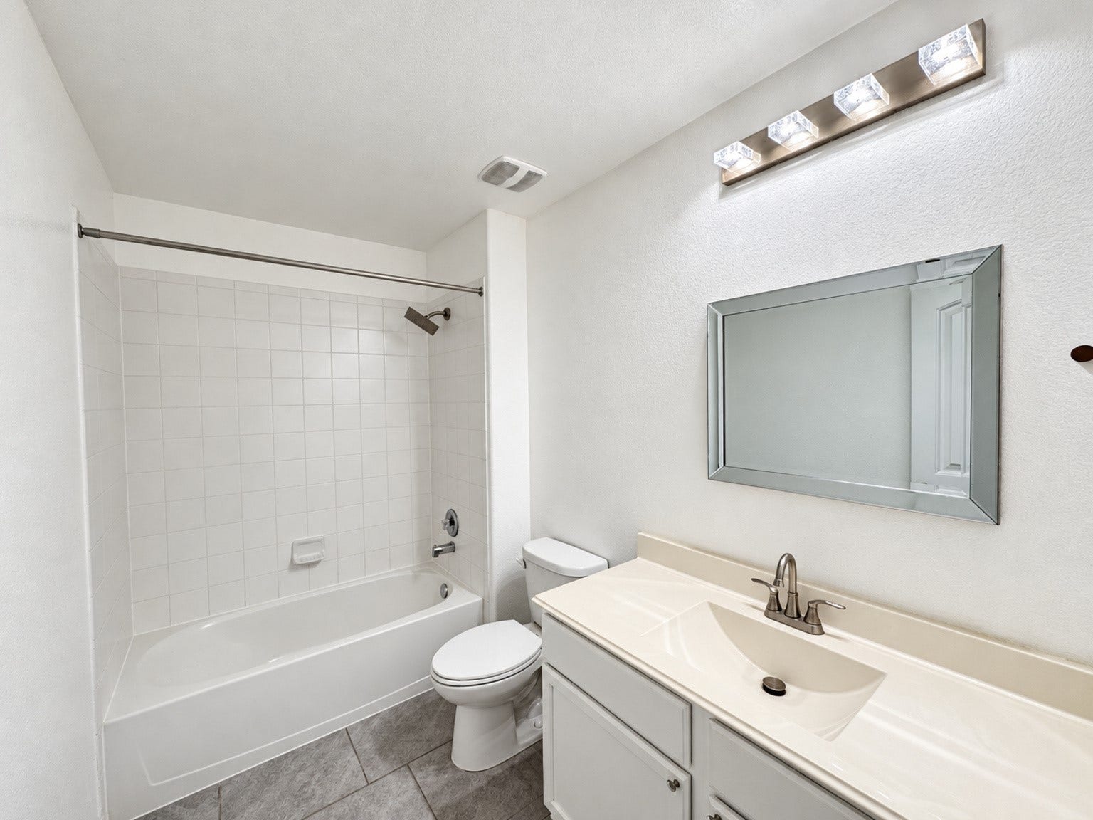 29202 Dunns Creek Court, Katy, TX 77494 Secondary bathroom with a tub-and-shower combination, white vanity, and tile flooring.