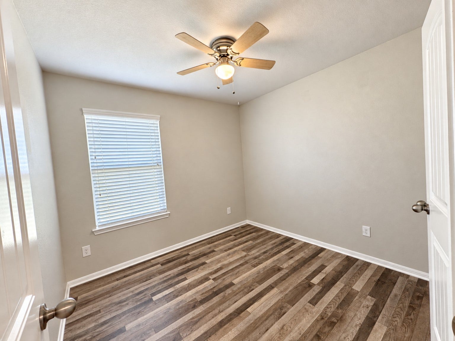 29202 Dunns Creek Court, Katy, TX 77494 Secondary bedroom featuring wood-look flooring, a ceiling fan, and natural light.