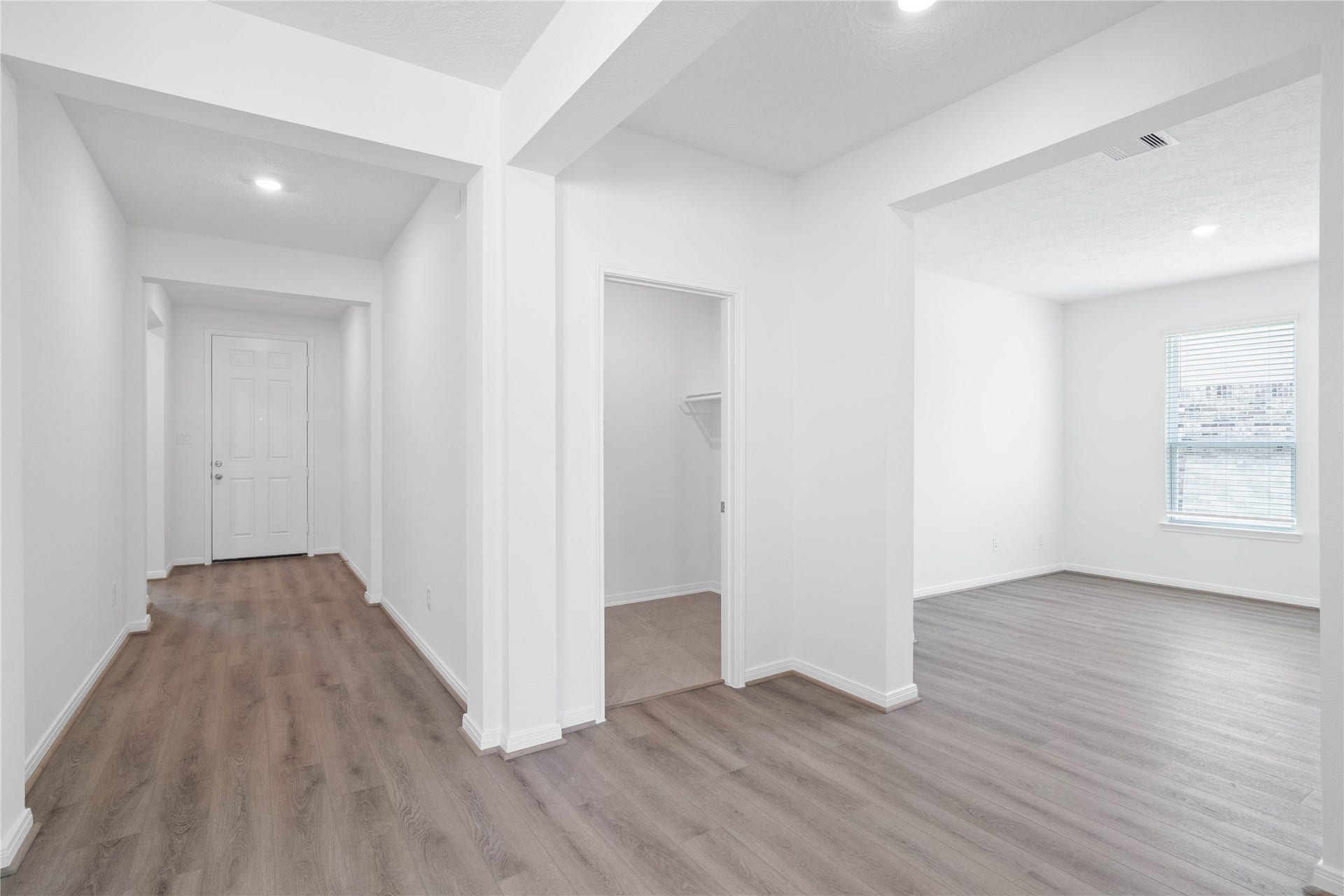Across the home from the secondary bedrooms and bathroom is a hallway that leads to the Den and laundry room.