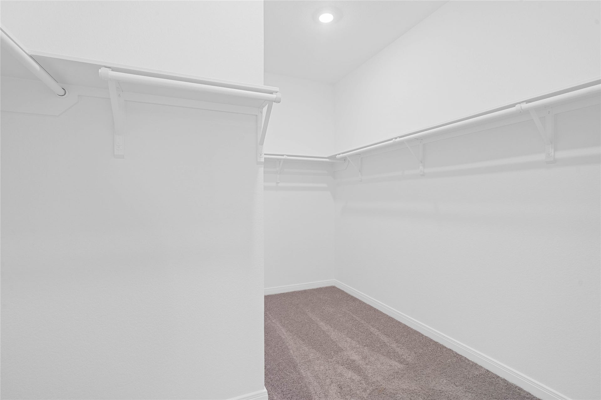 Experience the convenience of a spacious walk-in closet designed to simplify your morning routine. There is plenty of room to keep your wardrobe organized and easily accessible.