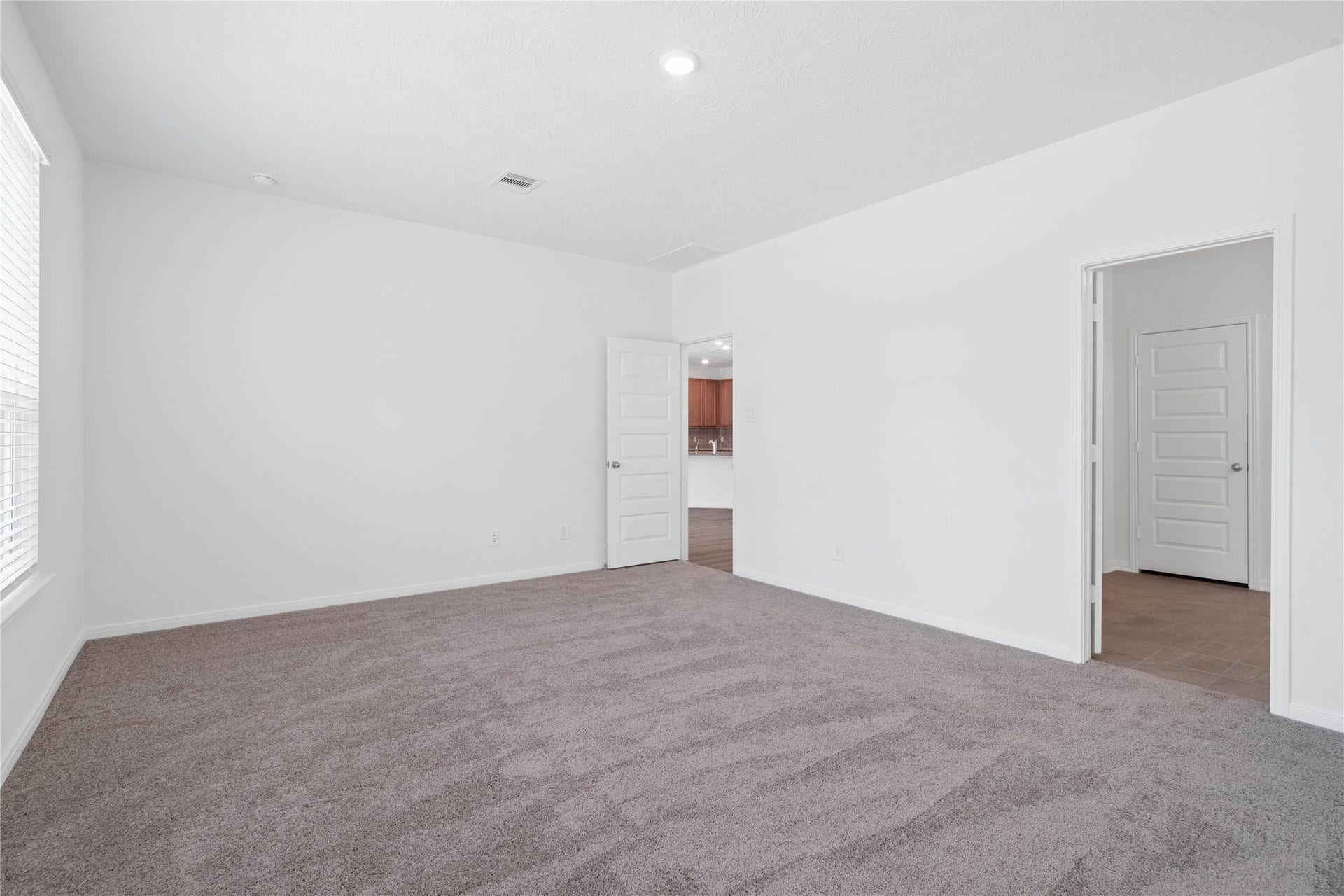Additional view of the primary bedroom looking towards the primary bathroom.