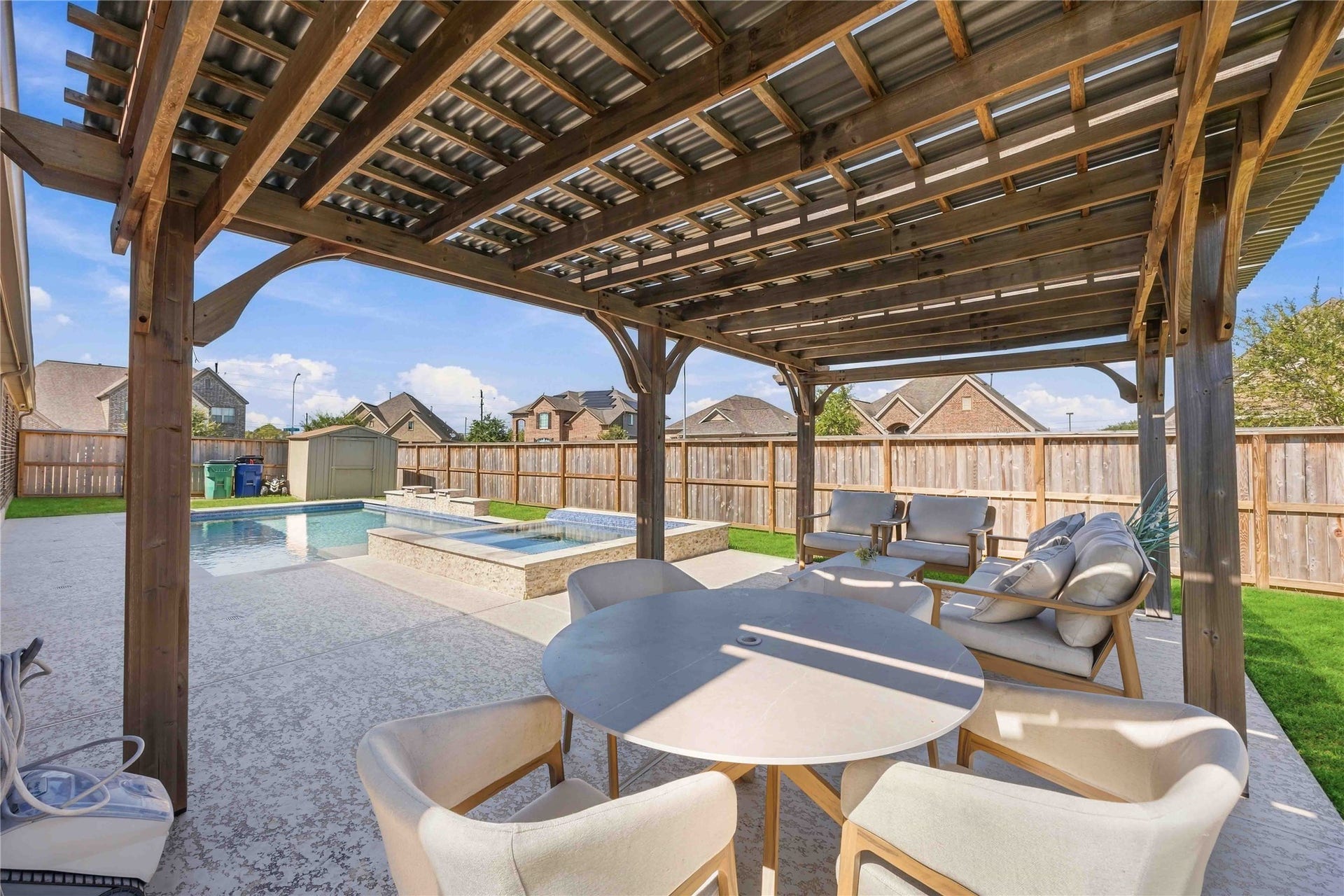 Relax and entertain in style beneath the charming pergola overlooking the sparkling pool. This inviting outdoor retreat creates the perfect setting for lounging, hosting guests, and enjoying beautiful poolside views in your own backyard oasis.