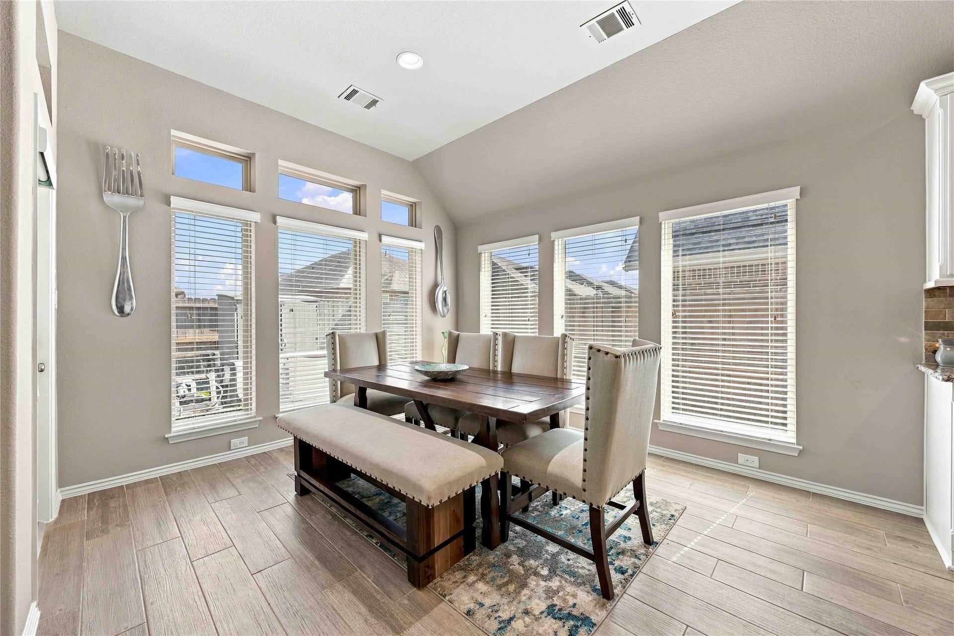 The charming breakfast nook offers the perfect spot to enjoy your morning coffee, casual meals, and everyday moments while adding warmth and functionality to the kitchen space.