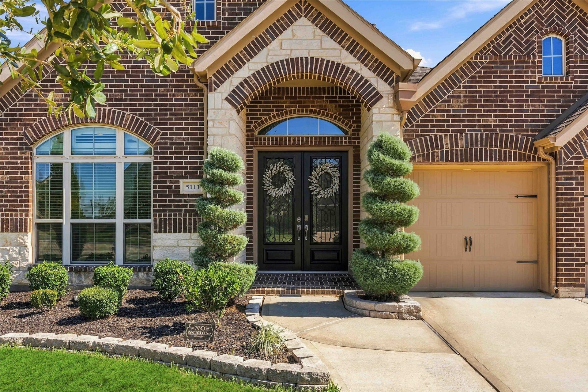 Beautiful home featuring manicured landscaping , a spacious driveway, and a two car garage.
