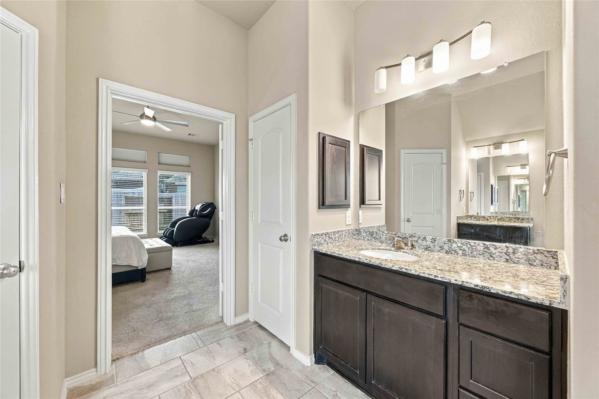 The primary bathroom features separate vanities, offering added convenience, personal space, and a functional layout to make busy mornings and everyday routines a breeze.