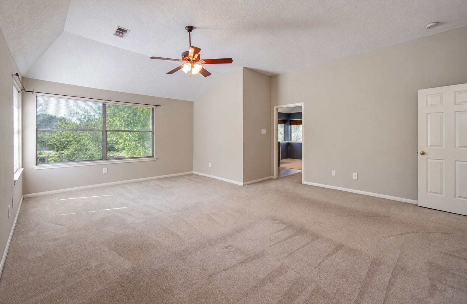 10003 Briarpark Trail Lane, Houston, TX 77064 Spacious upstairs primary retreat offers room for substantial bedroom furniture and a comfortable sitting area, with windows bringing in natural light.