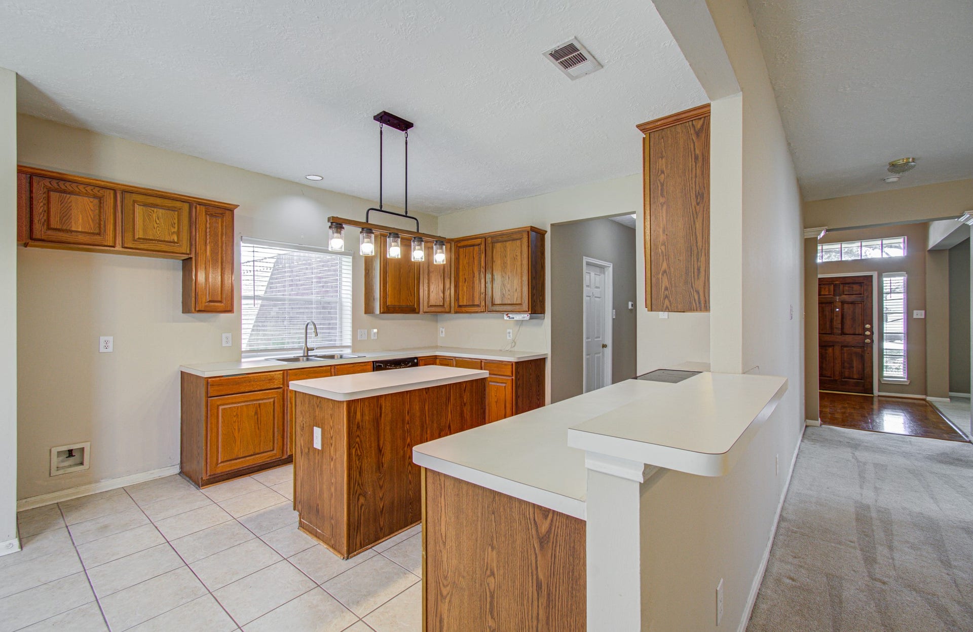 10003 Briarpark Trail Lane, Houston, TX 77064 Connected for everyday living! Kitchen offers an island for additional prep space, plentiful cabinet storage and an easy flow to the adjoining gathering areas.