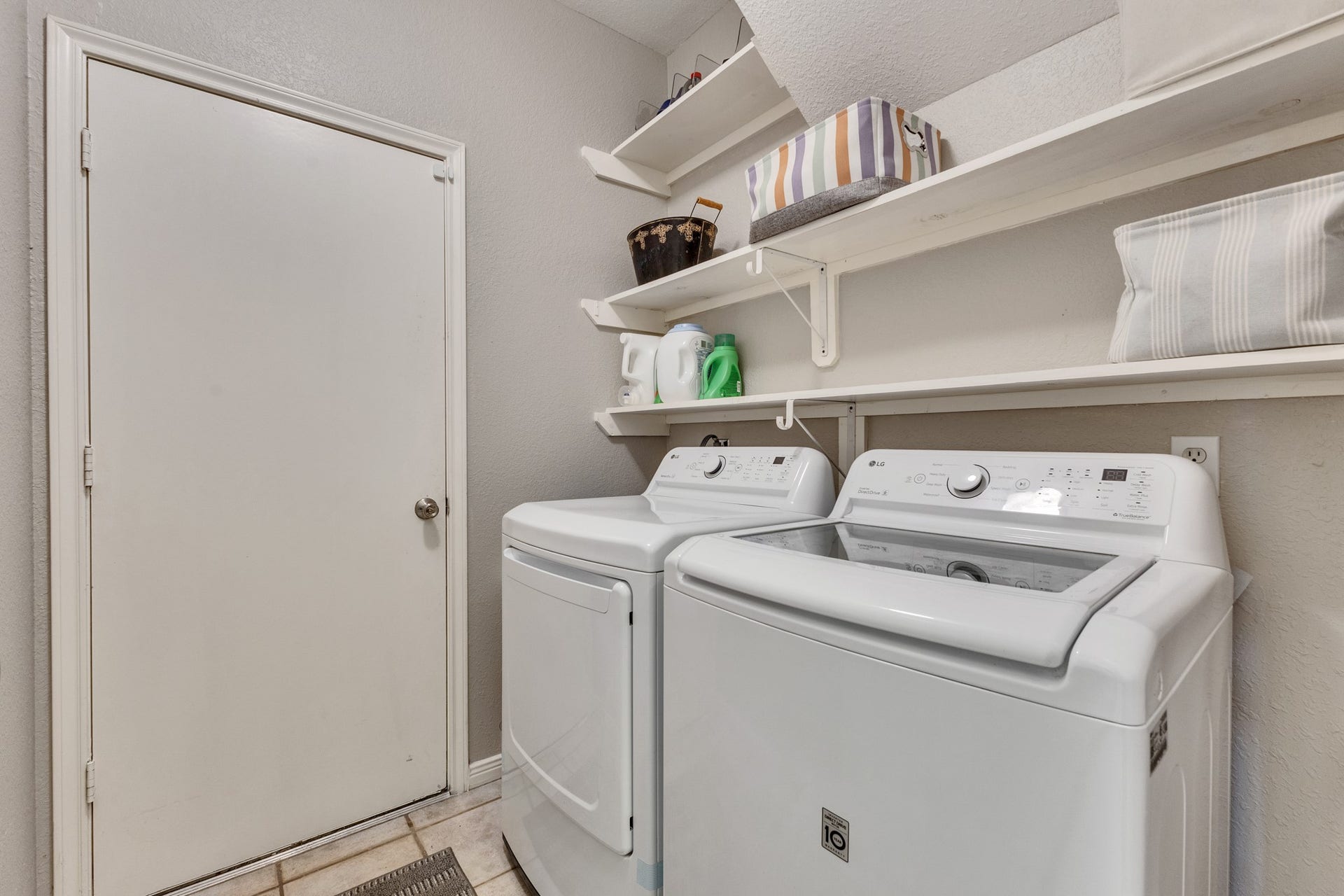 2922 Calendar Lake Drive, Missouri City, TX 77459 Laundry room with smple shelves for storage. Door is entry to the 2 car garage