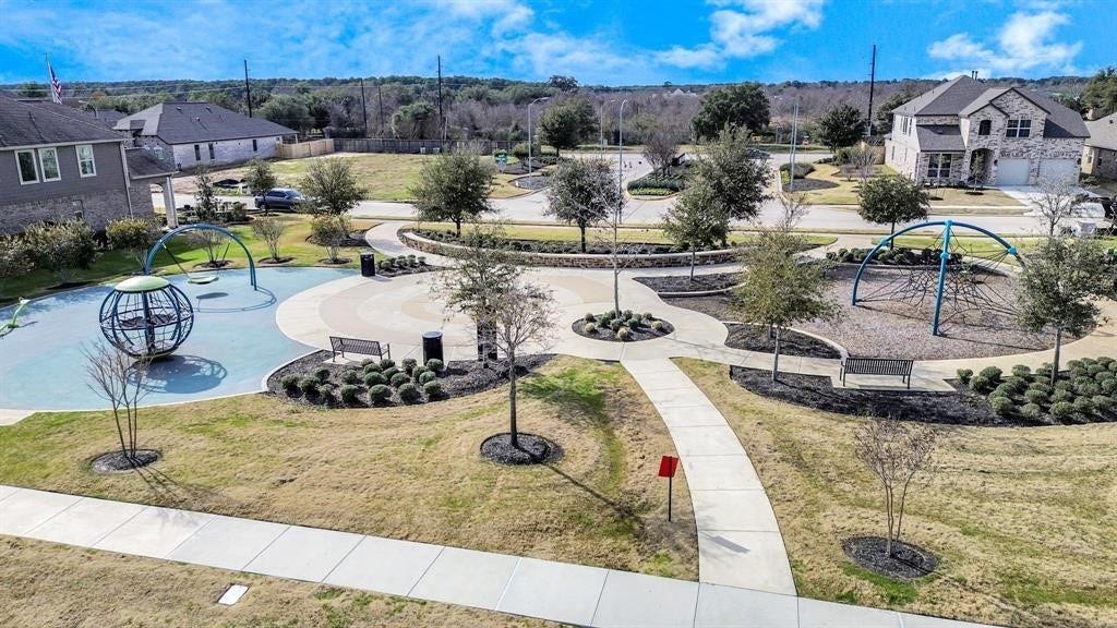 Charming neighborhood park featuring modern play structures, neatly landscaped pathways, and inviting benches, perfect for family enjoyment and relaxation.
