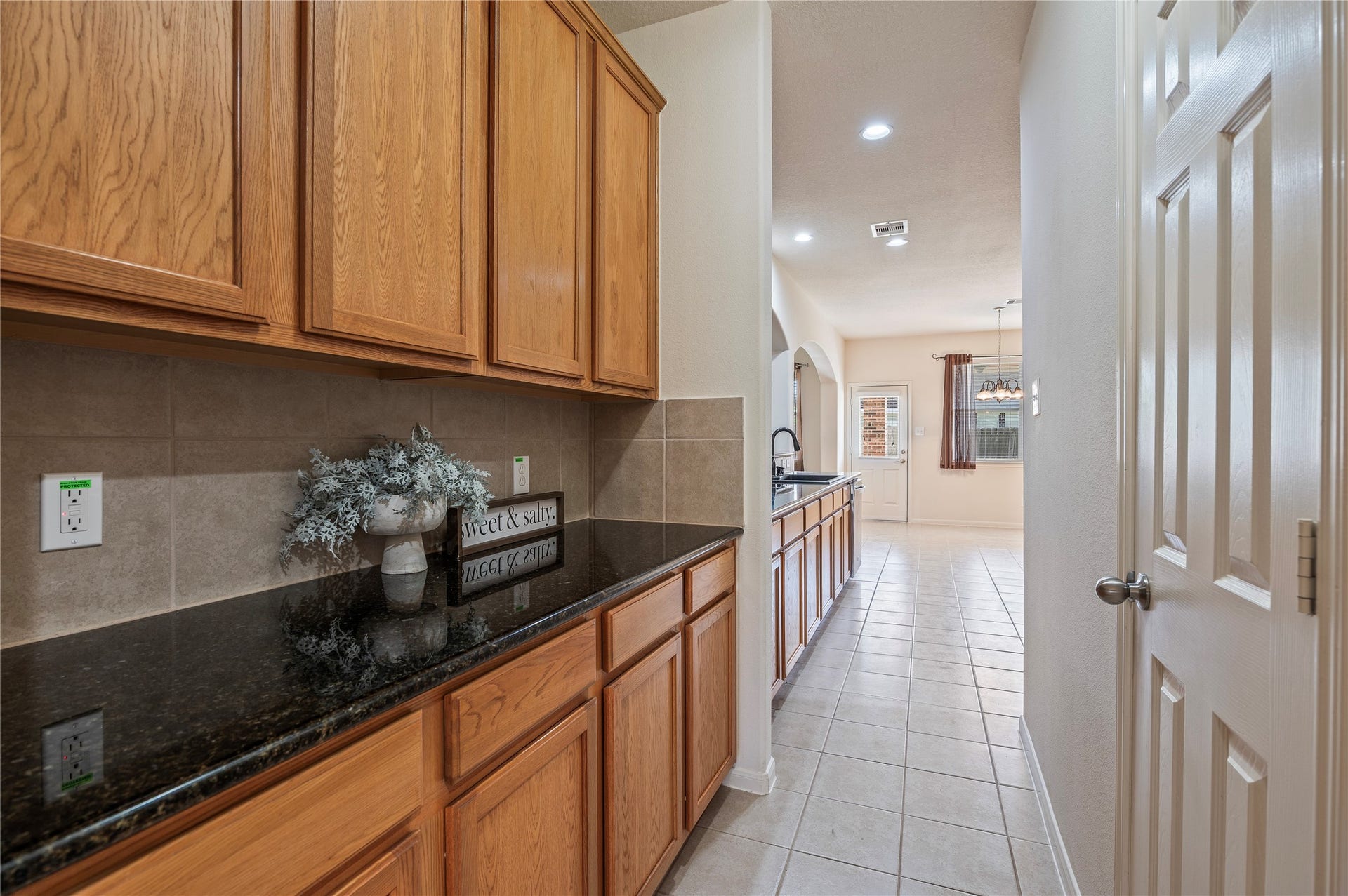 4404 Cypress Meadows Court, Dickinson, TX 77539 A butler's pantry with extra counter space connects the kitchen and dining room, perfect for serving and storage.