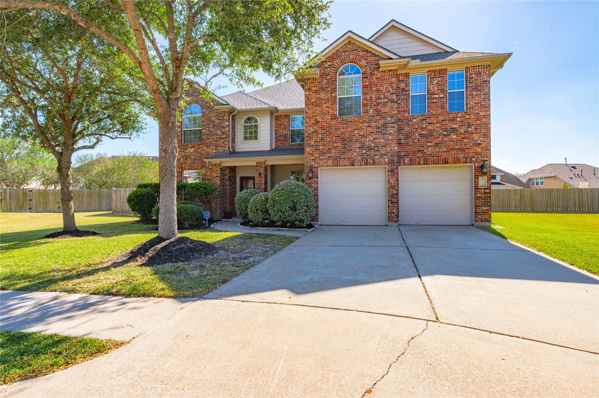 4404 Cypress Meadows Court, Dickinson, TX 77539 The extra-wide driveway leads to an attached 2-car garage with automatic door opener, with room for additional parking.