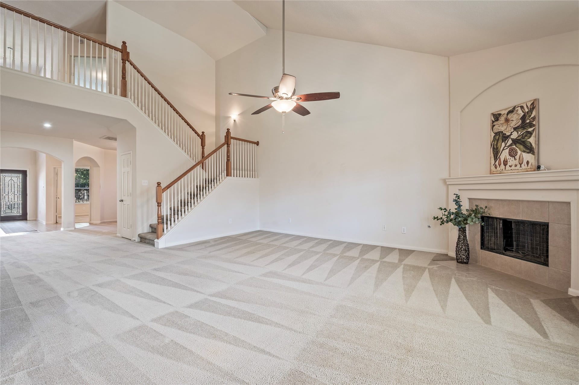 4404 Cypress Meadows Court, Dickinson, TX 77539 A stone fireplace with gas logs anchors the family room, with the staircase rising to the second floor.