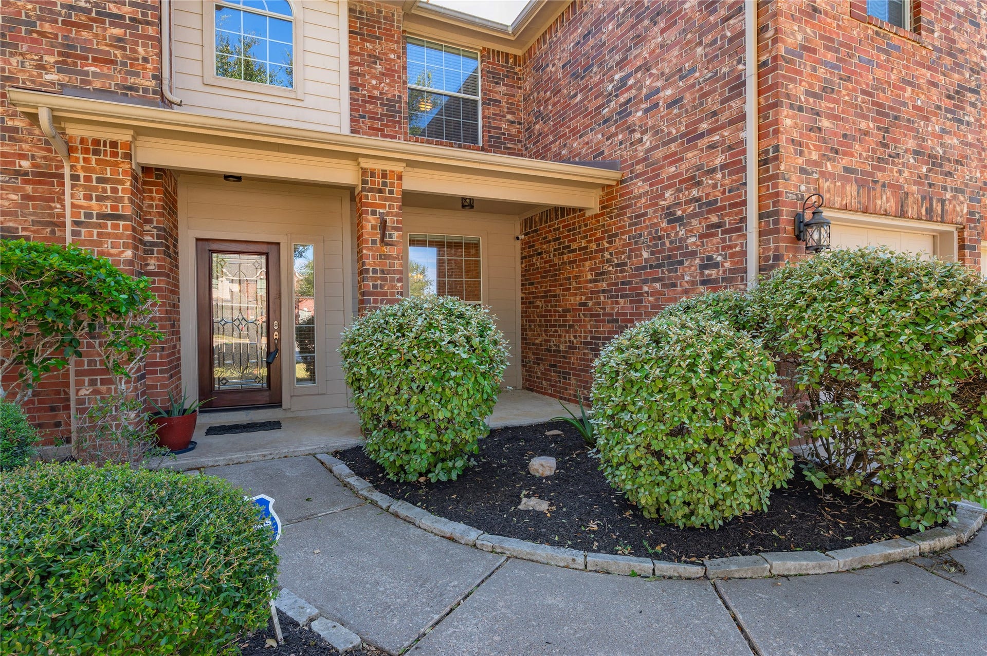 4404 Cypress Meadows Court, Dickinson, TX 77539 Well-kept landscaping beds line the walkway, adding color and curb appeal right up to the front porch.