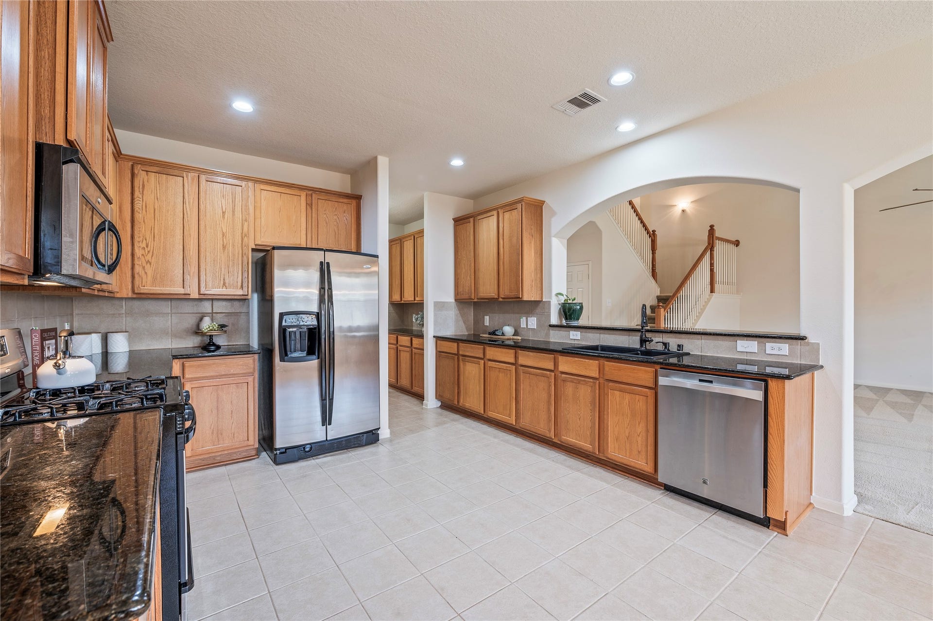 4404 Cypress Meadows Court, Dickinson, TX 77539 Plenty of counter and storage space in this kitchen, with stainless steel appliances, a gas range and built-in microwave.