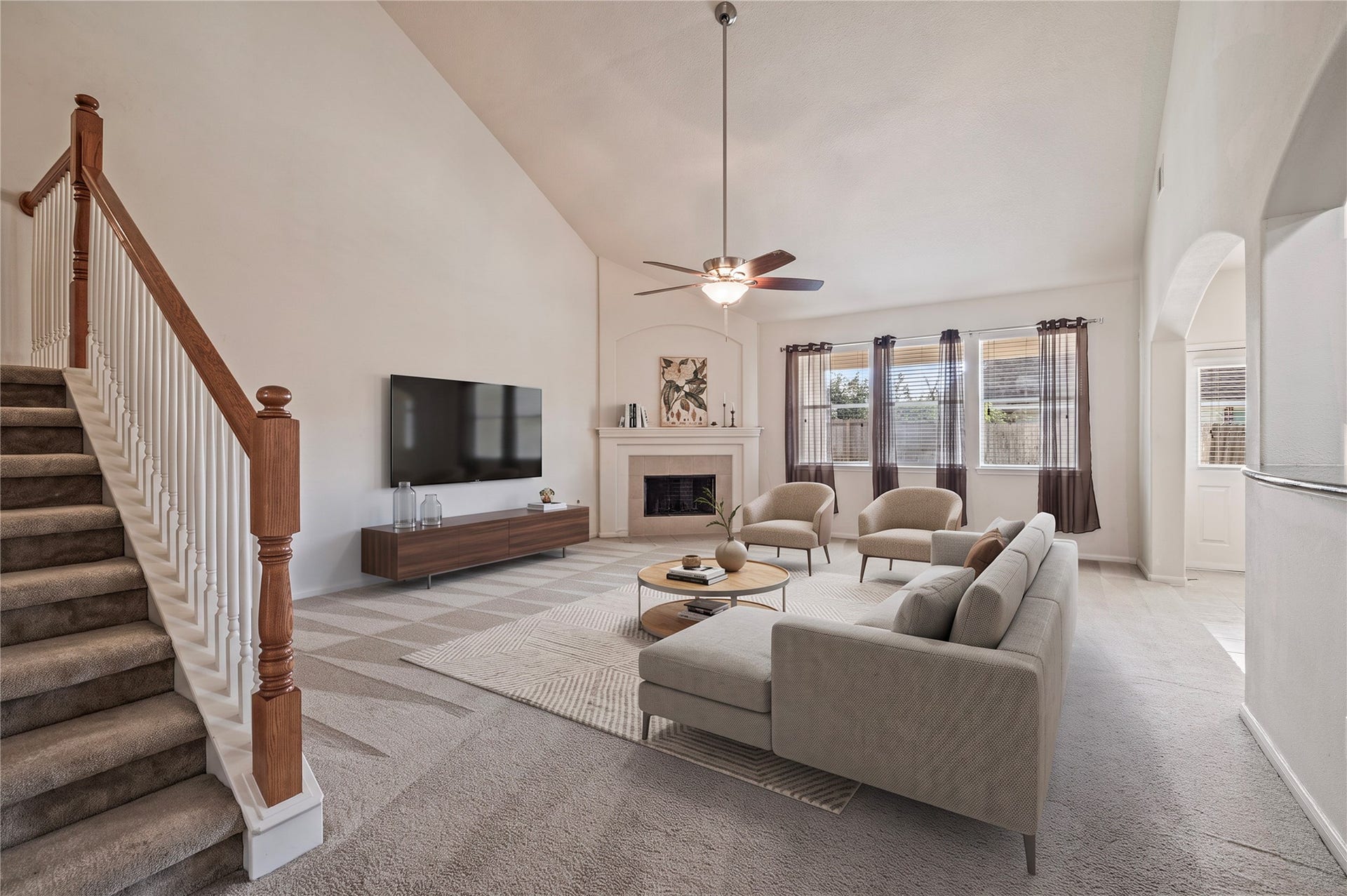 4404 Cypress Meadows Court, Dickinson, TX 77539 The grand family room features soaring ceilings, a ceiling fan and views of the large backyard. Room is virtually staged.