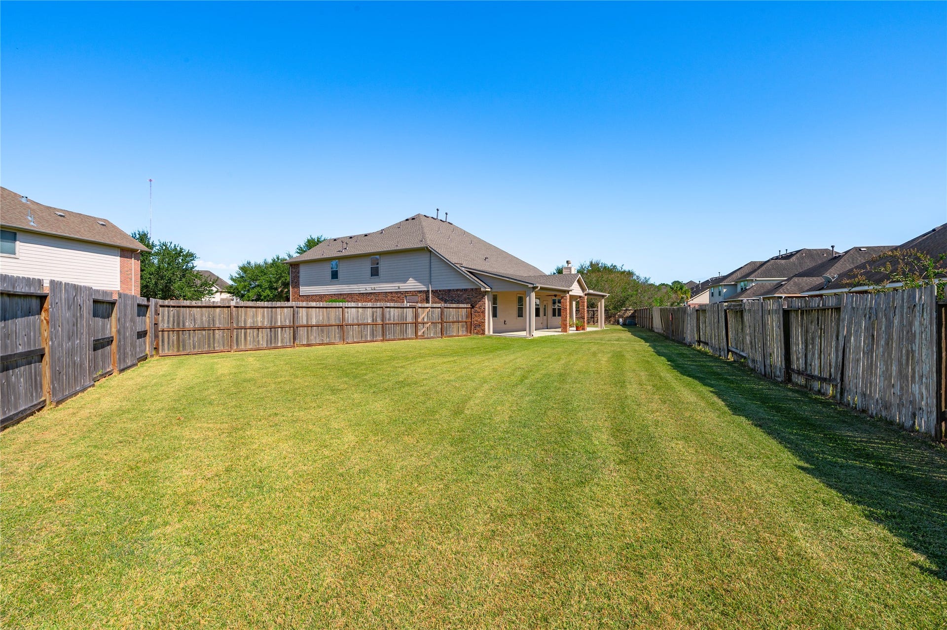 4404 Cypress Meadows Court, Dickinson, TX 77539 The expansive backyard offers wide open green space to enjoy.