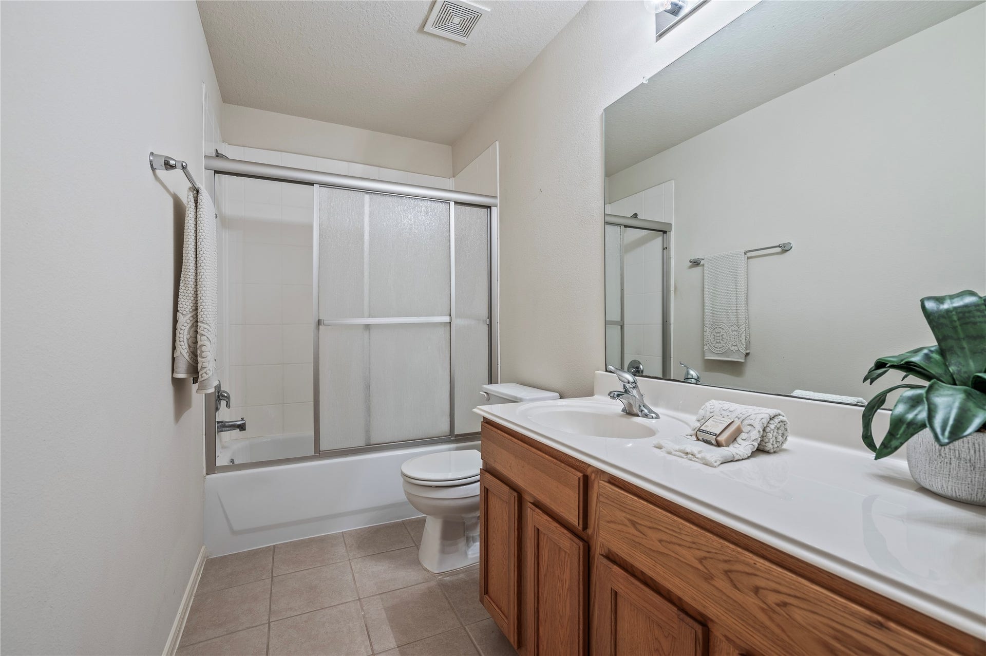 4404 Cypress Meadows Court, Dickinson, TX 77539 The third full bath, also upstairs, offers a large vanity, tile flooring and a shower with glass sliding doors.