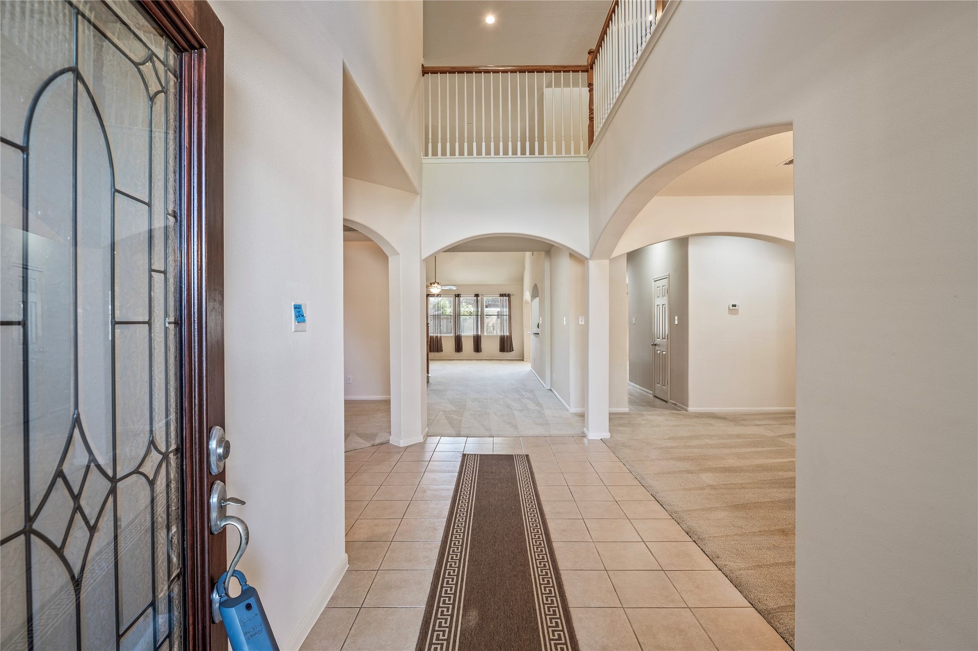 4404 Cypress Meadows Court, Dickinson, TX 77539 Step inside to a dramatic two-story entry with soaring 19-ft ceilings and durable tile flooring.