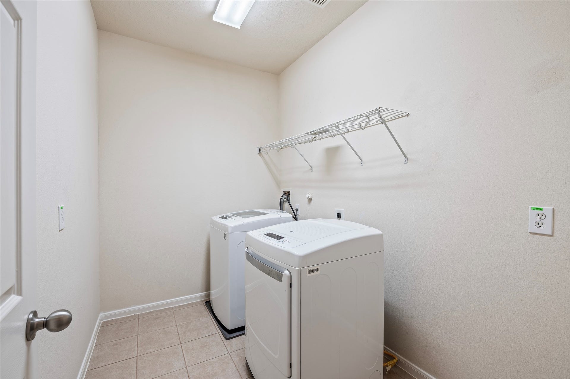 4404 Cypress Meadows Court, Dickinson, TX 77539 The large first-floor utility room with tile flooring has connections for gas or electric dryers.