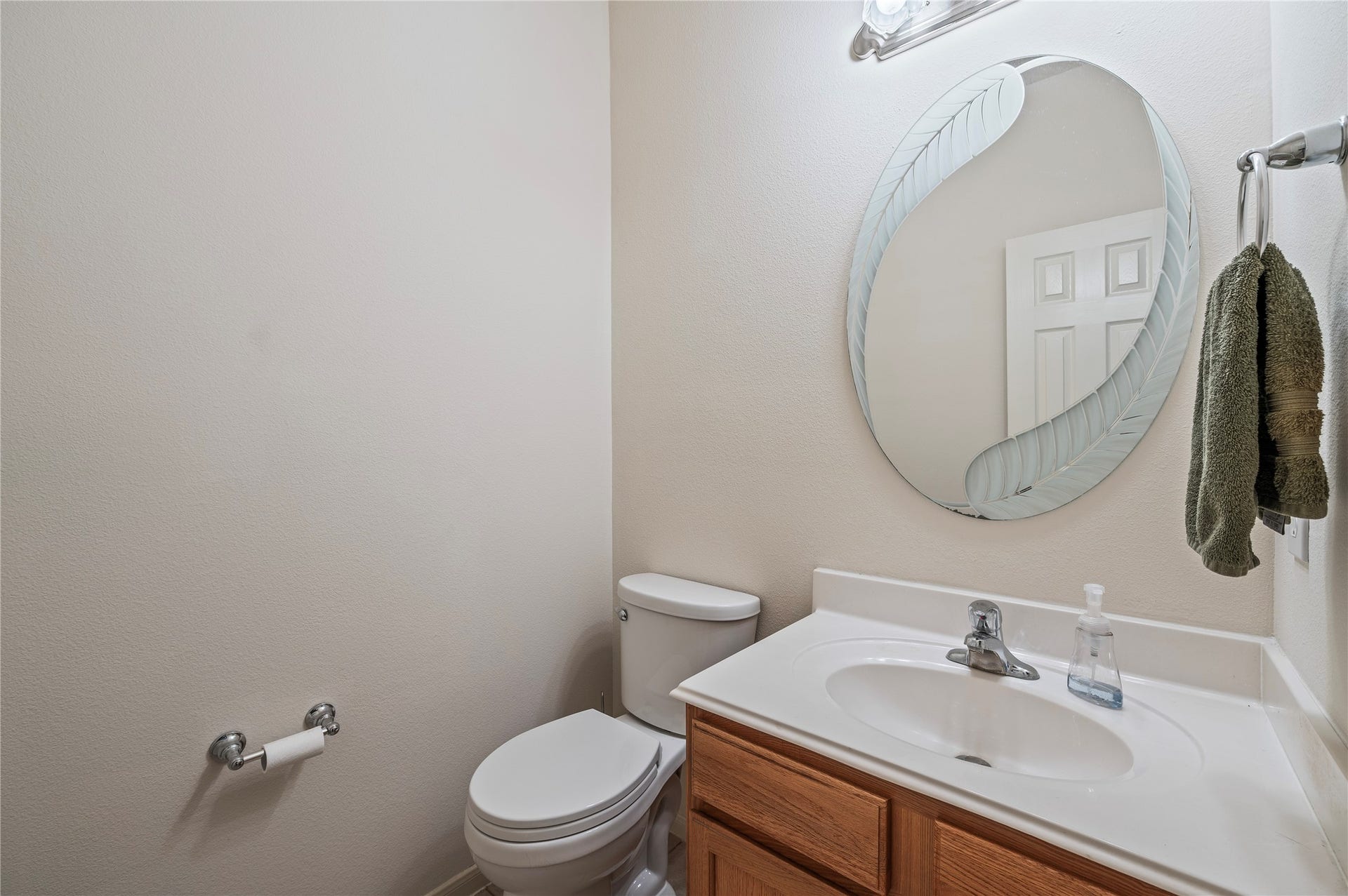4404 Cypress Meadows Court, Dickinson, TX 77539 A convenient first-floor half bath for guests, with vanity and tile flooring.