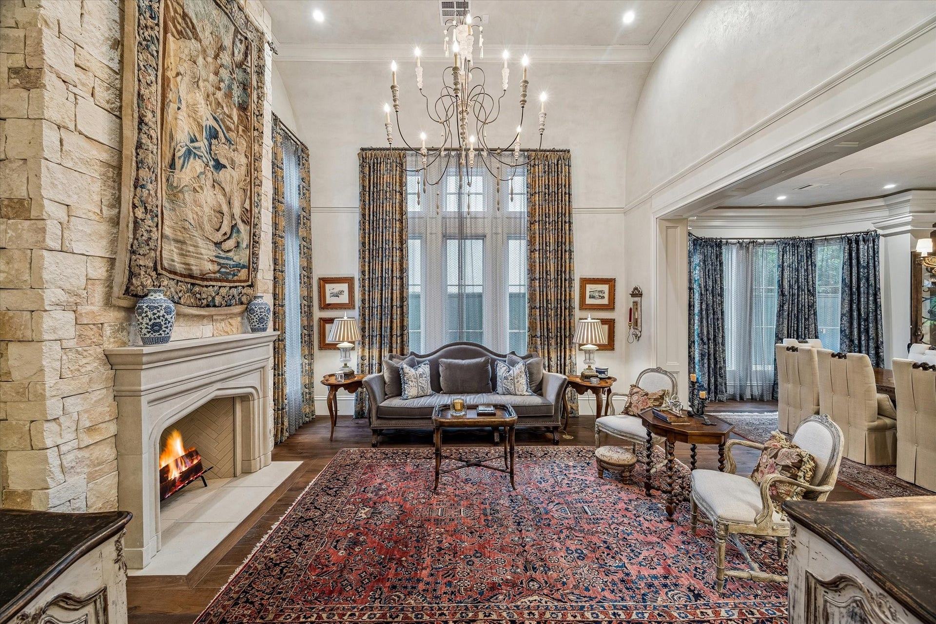 2158 Chilton Road, Houston, TX 77019 Refined and airy, the formal living room showcases exquisite Segreto plaster finishes and a limestone-clad fireplace. Open to the foyer and dining room, it offers a seamless flow for elevated entertaining.