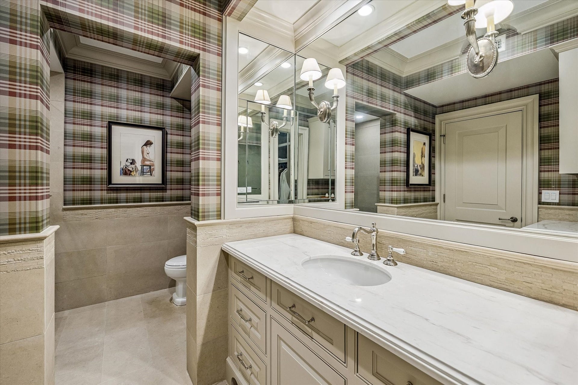 2158 Chilton Road, Houston, TX 77019 This bathroom blends elegance and functionality with marble countertops, a tile bath/shower, polished nickel sconces, and custom plaid designer wallcovering. Crown molding adds a refined touch.