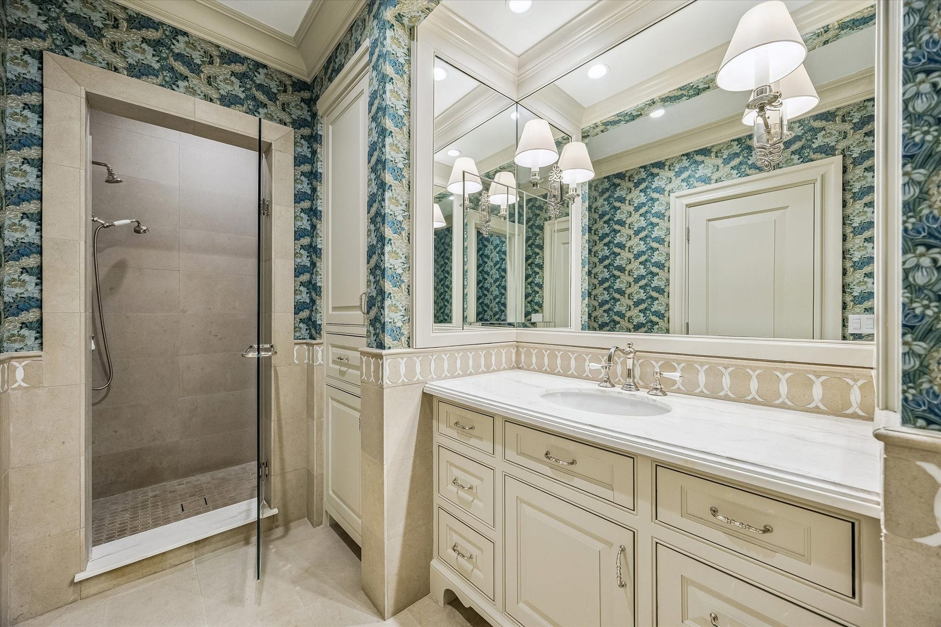 2158 Chilton Road, Houston, TX 77019 The ensuite bathroom features marble countertops, a walk-in shower with bench seating, and Rohl polished nickel hardware. Designer wallcovering and crown molding create a sophisticated guest space.