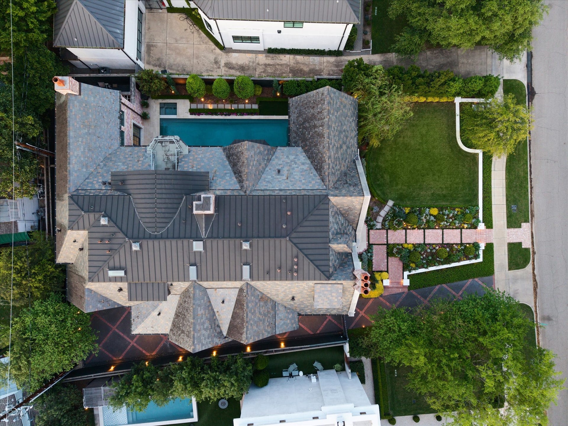 2158 Chilton Road, Houston, TX 77019 A sweeping aerial view showcases the homes prime River Oaks location, highlighting the lush front lawn, sparkling pool and spa, manicured landscaping, and elegant architectural details. The propertys generous lot and surrounding greenery create a private and inviting setting.