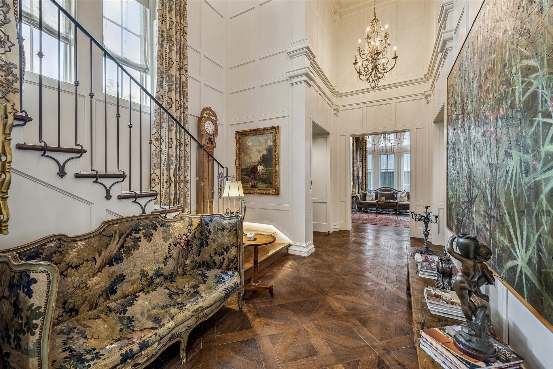 2158 Chilton Road, Houston, TX 77019 The stunning foyer features versailles parquet hardwood floors, double-height ceilings, and a designer chandelier that sets an elegant tone upon entry. Cased openings lead to the formal living room, family room, and library, while a custom staircase and Inclinator elevator provide graceful access to the upper floors.