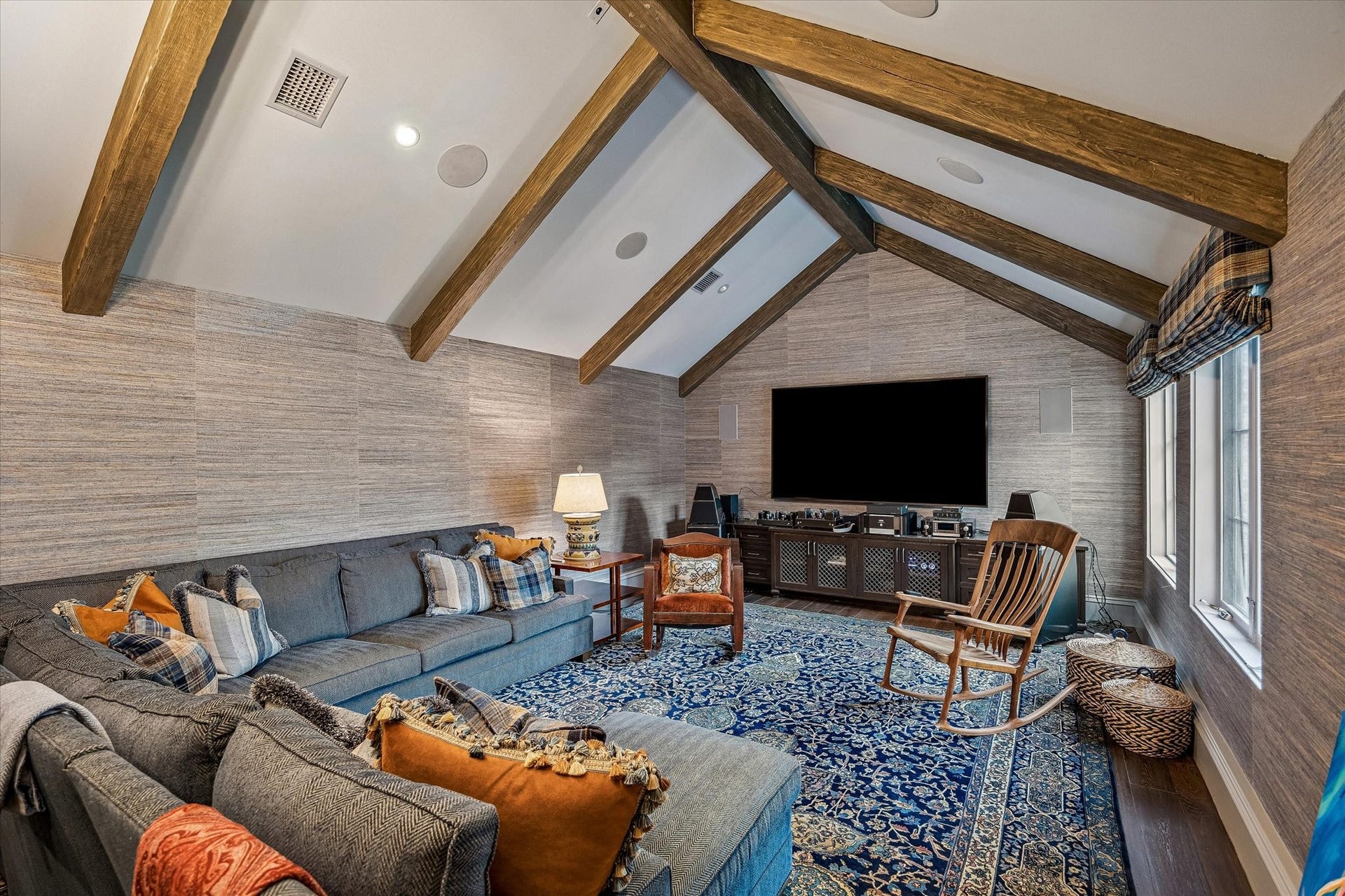 2158 Chilton Road, Houston, TX 77019 The second floor spacious game room features vaulted wood-beamed ceilings, designer grasscloth walls, and built-in ceiling speakers for an elevated entertainment experience. A wet bar with marble countertops and a SubZero beverage refrigerator, along with southern-facing windows and custom treatments, make this room perfect for fun and relaxation.