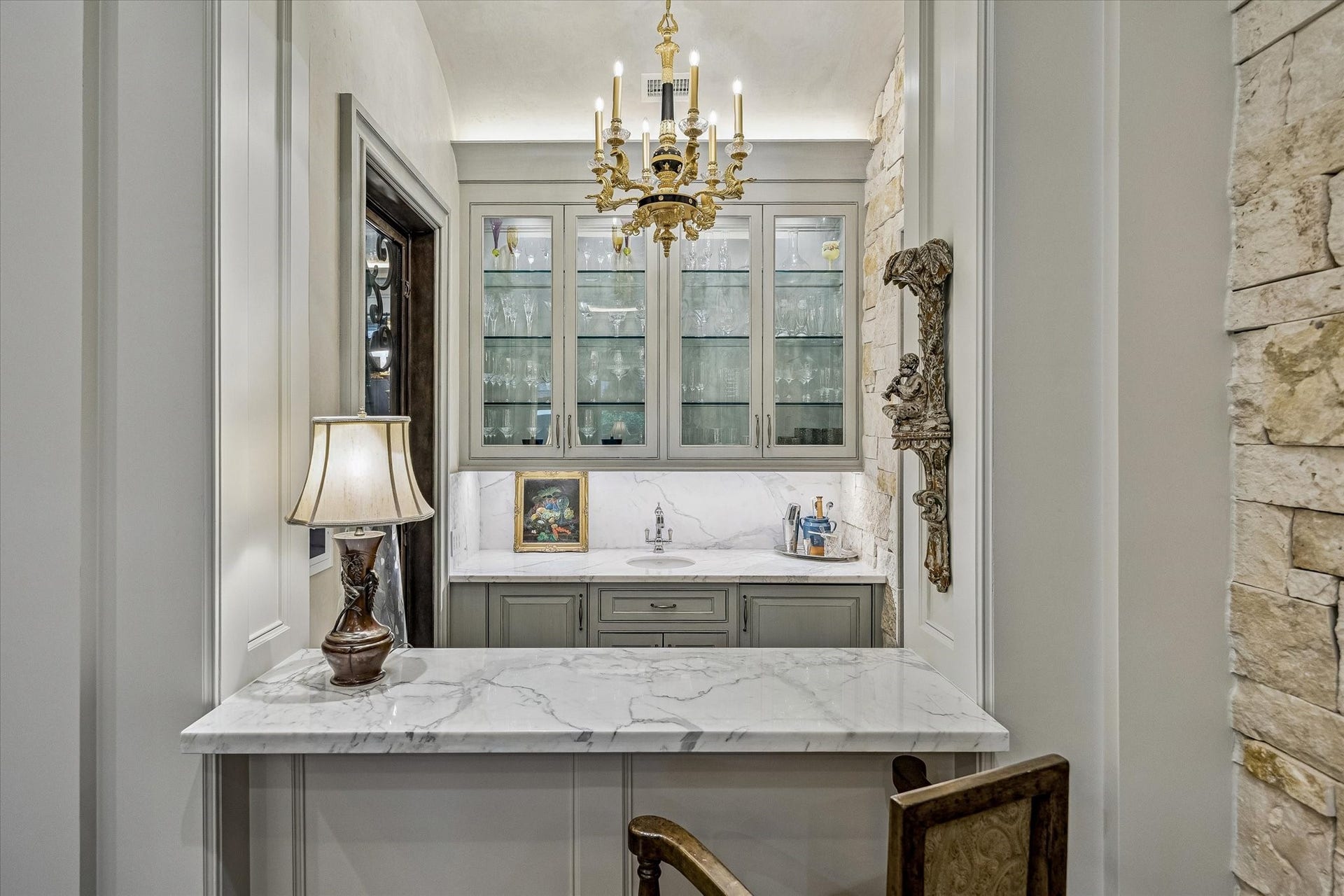 2158 Chilton Road, Houston, TX 77019 Ideally positioned between the main living spaces, the wet bar features marble countertops, glass-front cabinetry, and premium appliances including a SubZero beverage refrigerator and ice maker. Designed for effortless entertaining, it serves as a stylish and functional hub.