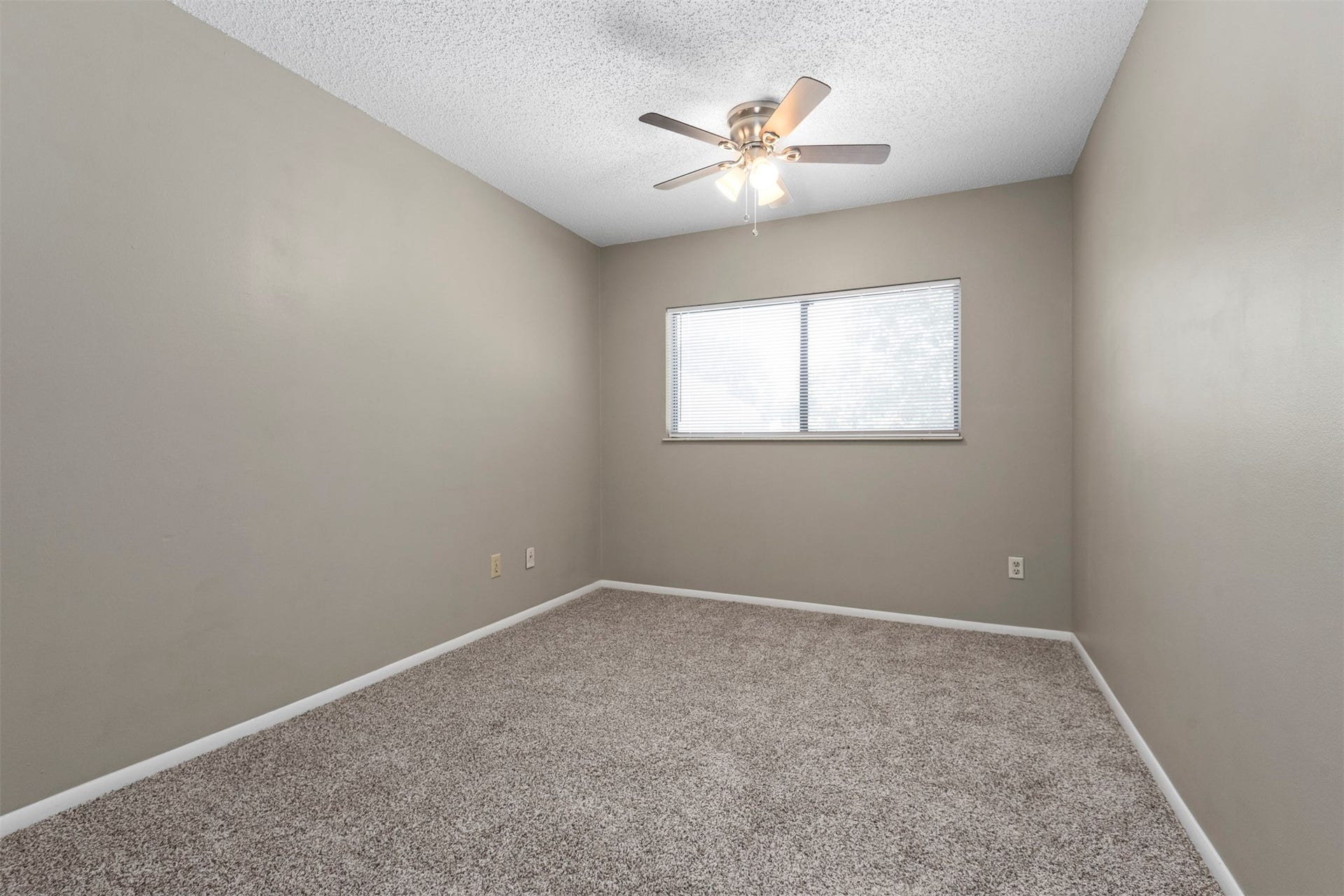 The second of the upstairs bedrooms is also spacious and has a ceiling fan.
