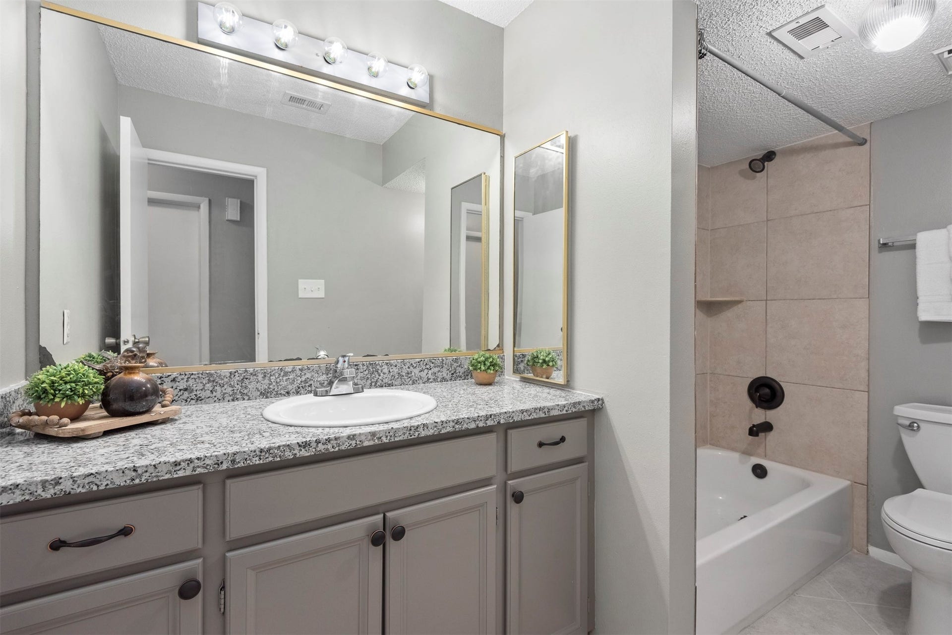 There is plenty of room in the upstairs secondary bathroom.  The large vanity has quite a bit of storage.
