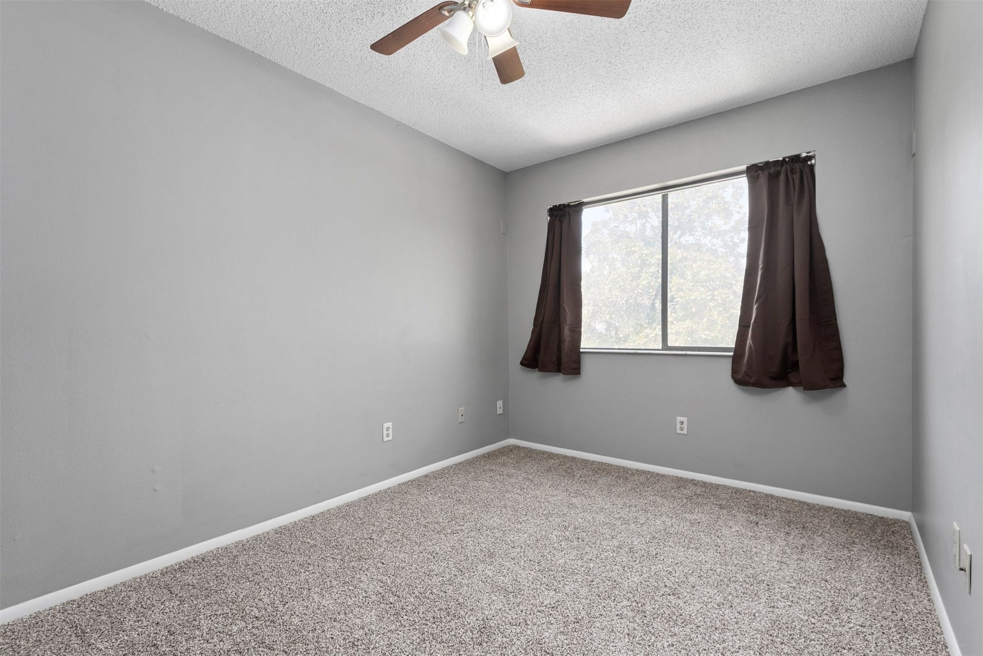The large game room window overlooks the front of the home.