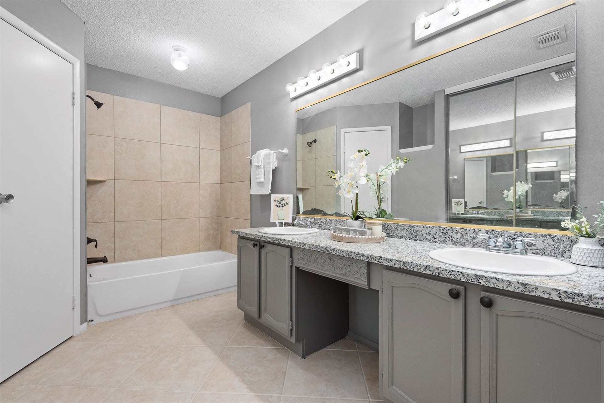 The primary bathroom boasts dual sinks, a shower tub combo, a water closet and a walk in closet.