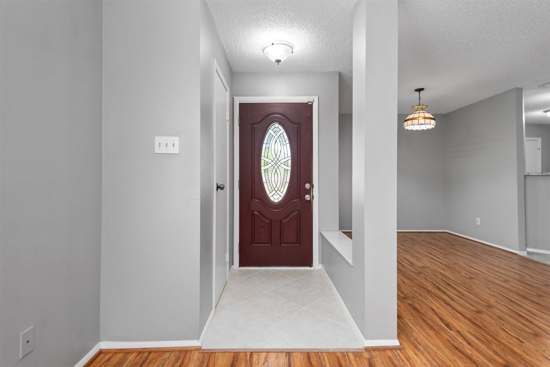The view toward the front door shows the dining area and front entry.