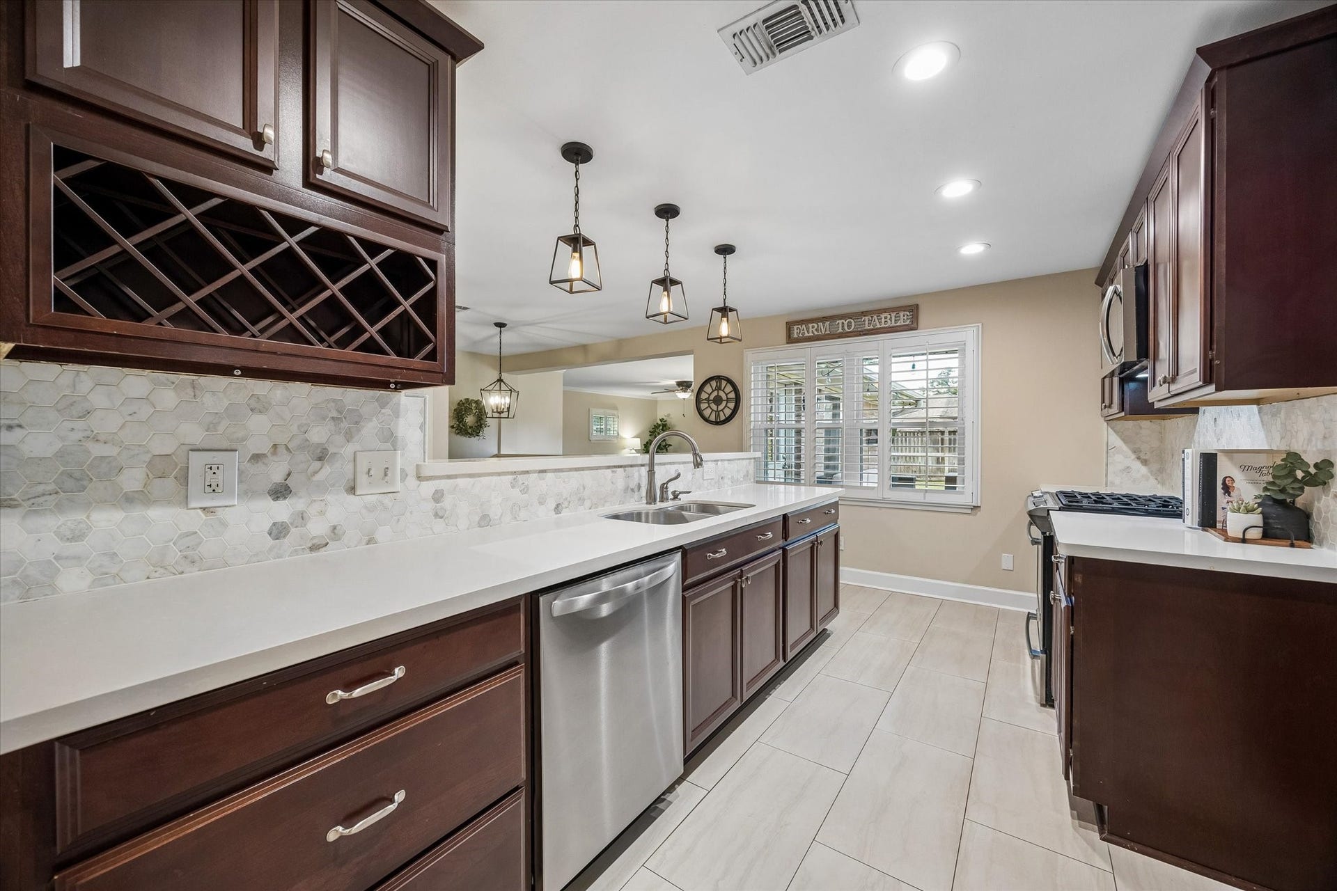2318 Cheshire Lane, Houston, TX 77018 Patterned backsplash and integrated wine storage add character and function to the kitchen. Long stretches of counter space and upper and lower cabinetry keep preparation areas and everyday essentials close at hand.
