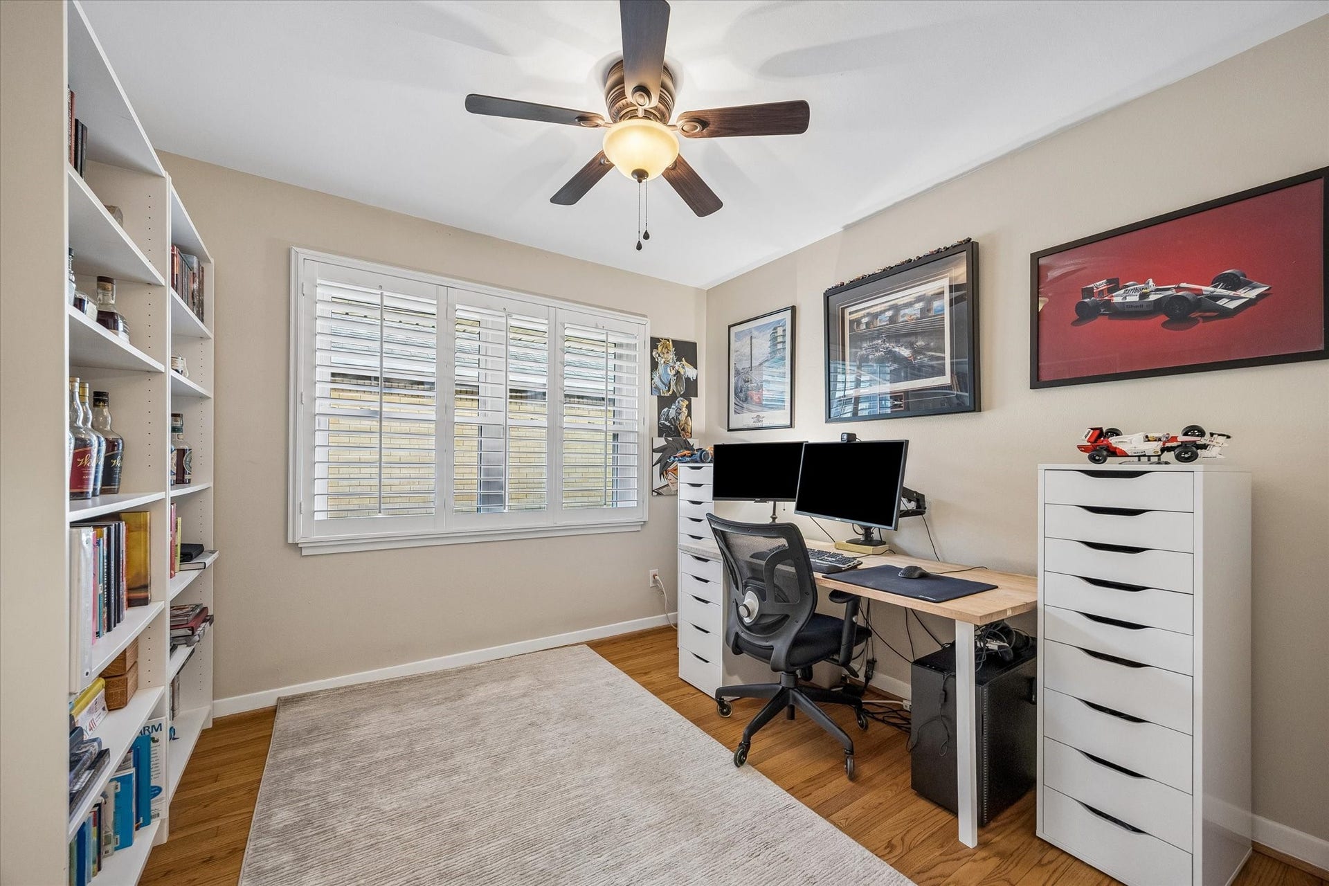 2318 Cheshire Lane, Houston, TX 77018 Flexible bedroom can also serve as a dedicated home office or hobby room. A shuttered window allows adjustable light and privacy, while wood floors and a ceiling fan carry through the home's interior finishes.