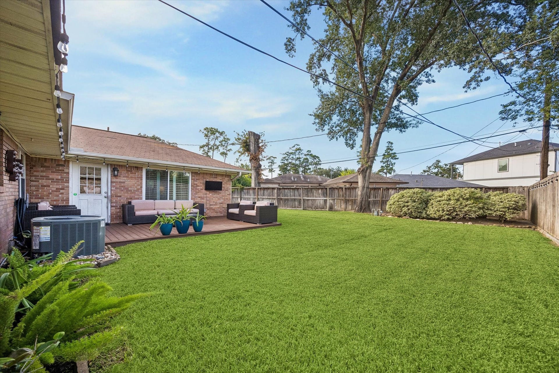 2318 Cheshire Lane, Houston, TX 77018 Mature tree and a broad fenced lawn give the backyard an inviting setting. Deck space alongside the house leaves room for outdoor recreation, gardening and gathering while offering different perspectives across the yard.