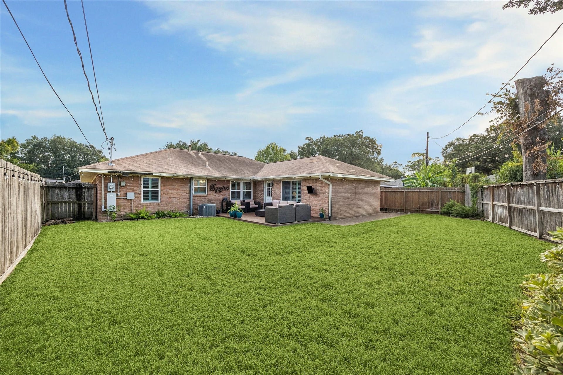 2318 Cheshire Lane, Houston, TX 77018 Wide rear view shows how the home, deck and lawn work together across the backyard. Open yard space adds flexibility for outdoor activities, while an irrigation system supports care of the front and back landscaping.