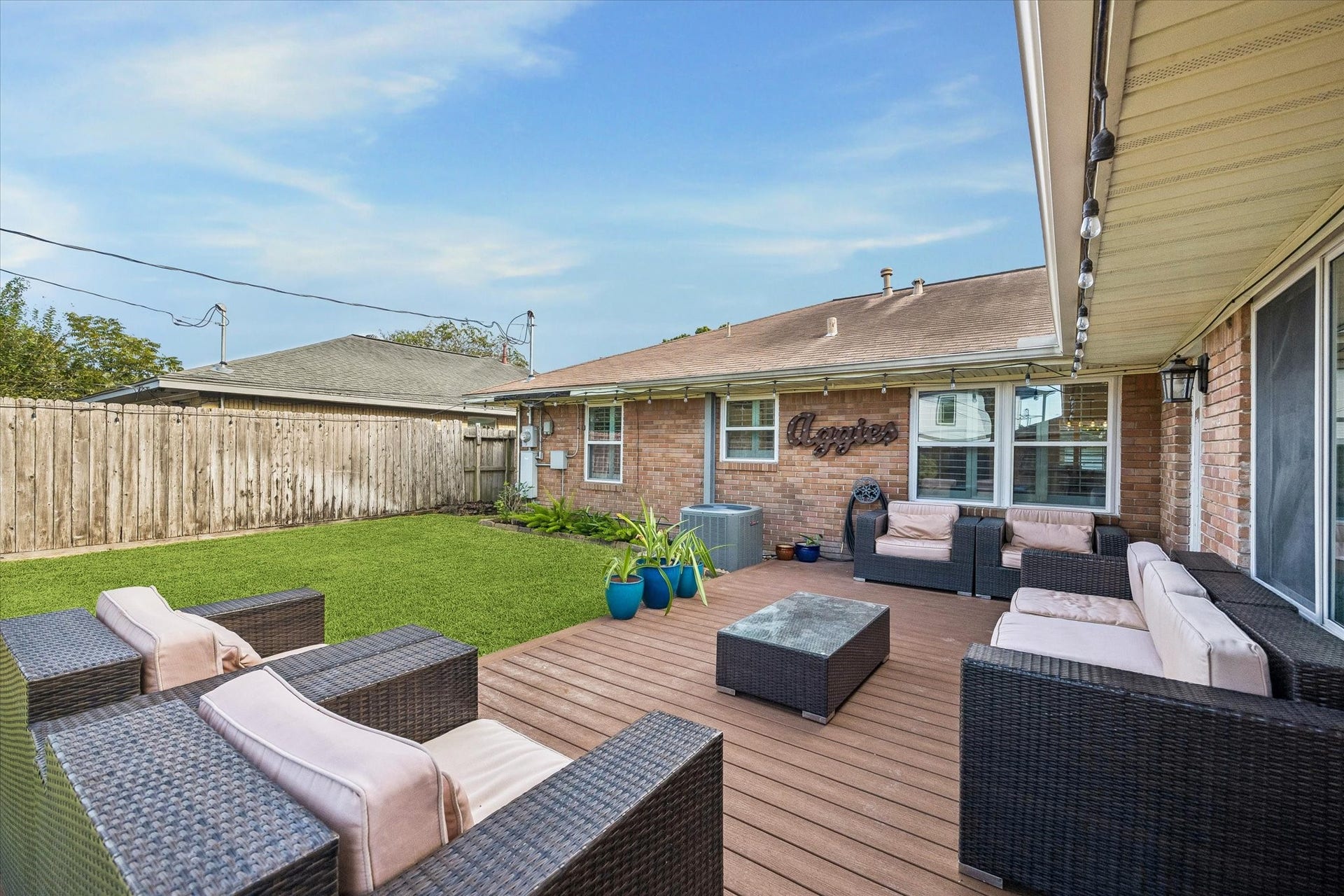 2318 Cheshire Lane, Houston, TX 77018 Views from the deck take in the lawn and the backyard's distinctive layout. Space for outdoor dining and relaxing connects directly with the yard, making the deck a useful extension of the home's main living areas.