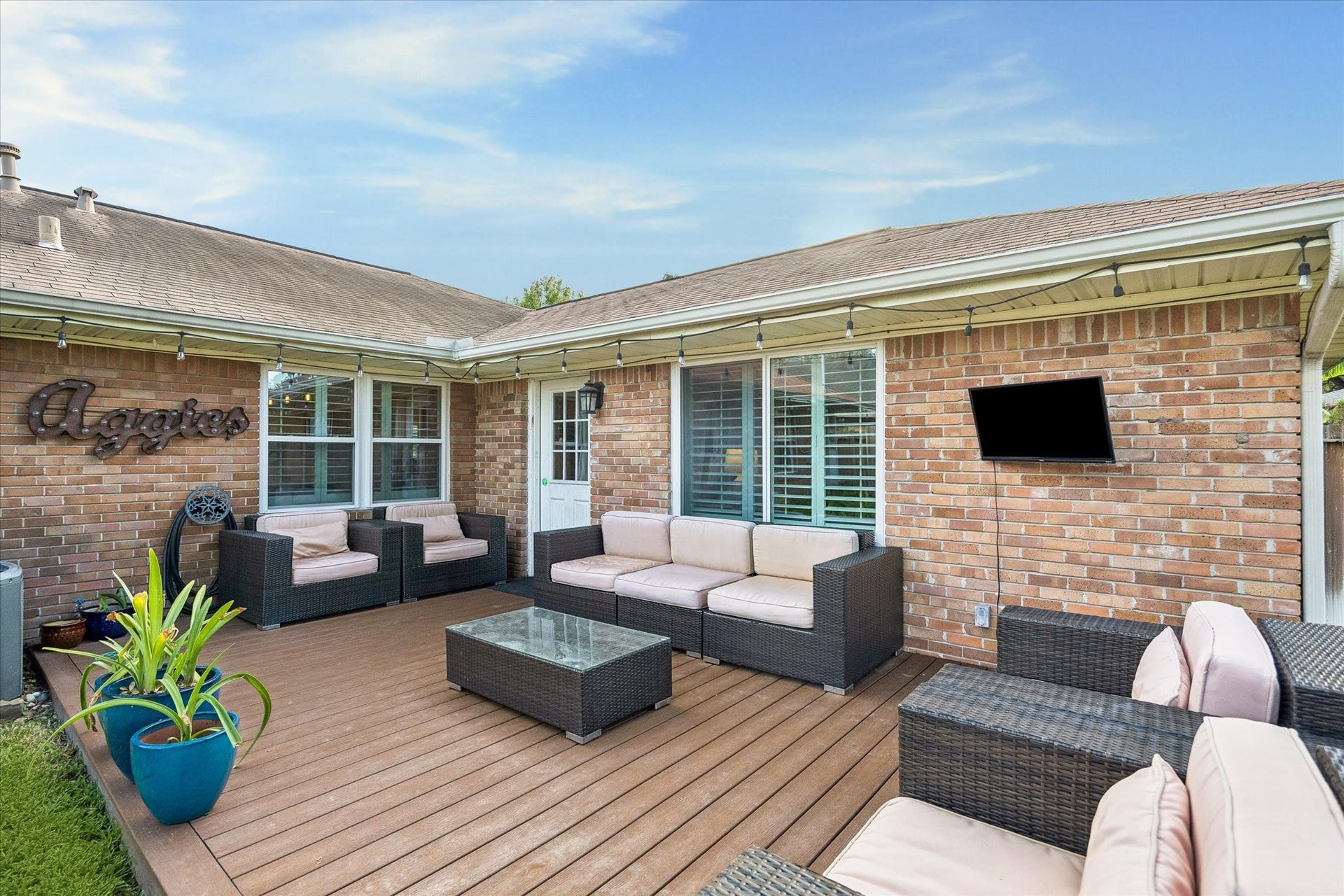 2318 Cheshire Lane, Houston, TX 77018 Large rear deck extends the home's living space outdoors with room for dining, gathering and relaxing. Its placement alongside the house creates an easy transition from the interior while keeping the backyard lawn available for other activities.