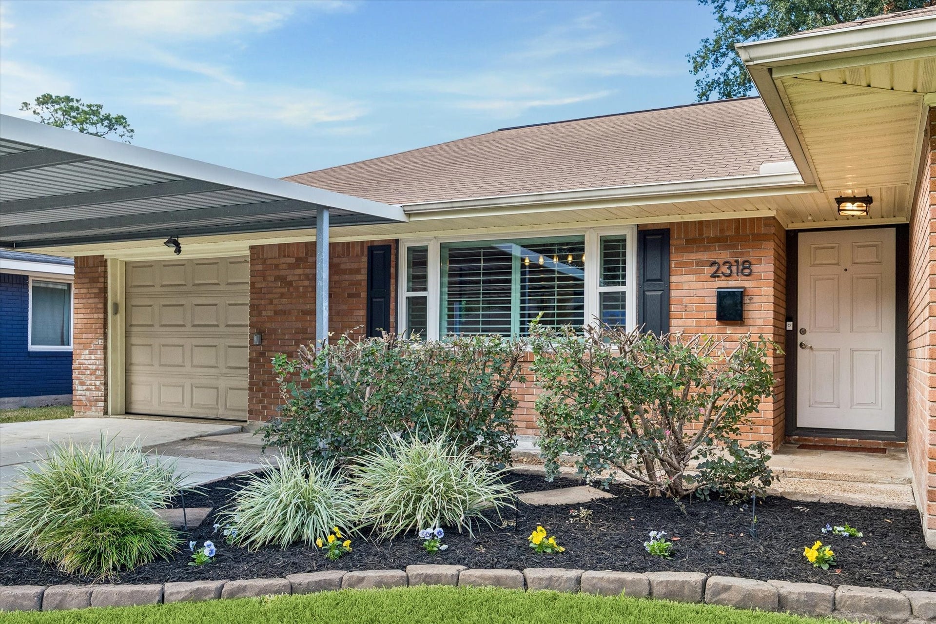 2318 Cheshire Lane, Houston, TX 77018 Landscaped beds frame the sheltered front entry and complement the home's classic brick exterior. Covered access creates a welcoming transition indoors, with an attractive front yard adding to the appeal from the street.