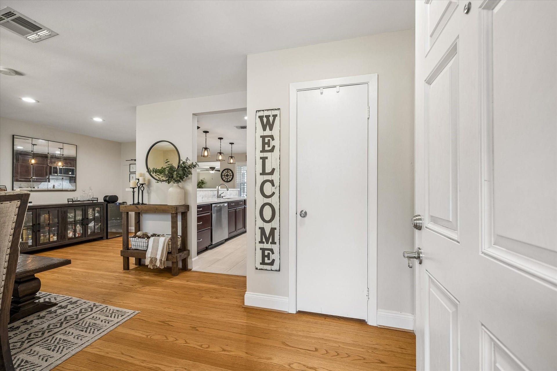 2318 Cheshire Lane, Houston, TX 77018 Wood floors carry through the entry into the front dining area, introducing the home's connected layout. Open circulation makes it easy to welcome guests and move between the kitchen, dining and living spaces.