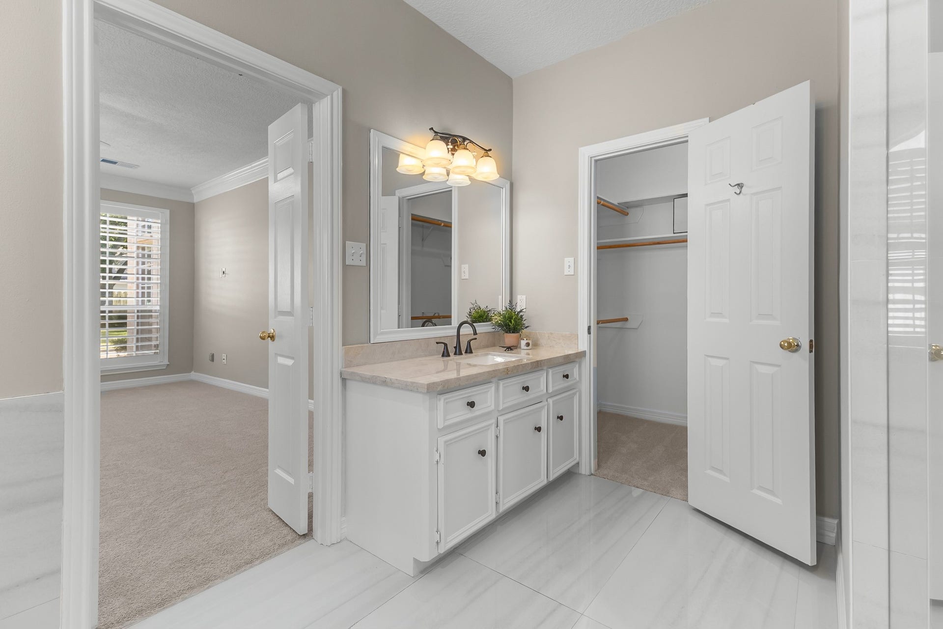 16314 Graven Hill Drive, Spring, TX 77379 A bright vanity area and adjoining closet access create a practical, well-connected primary suite layout.