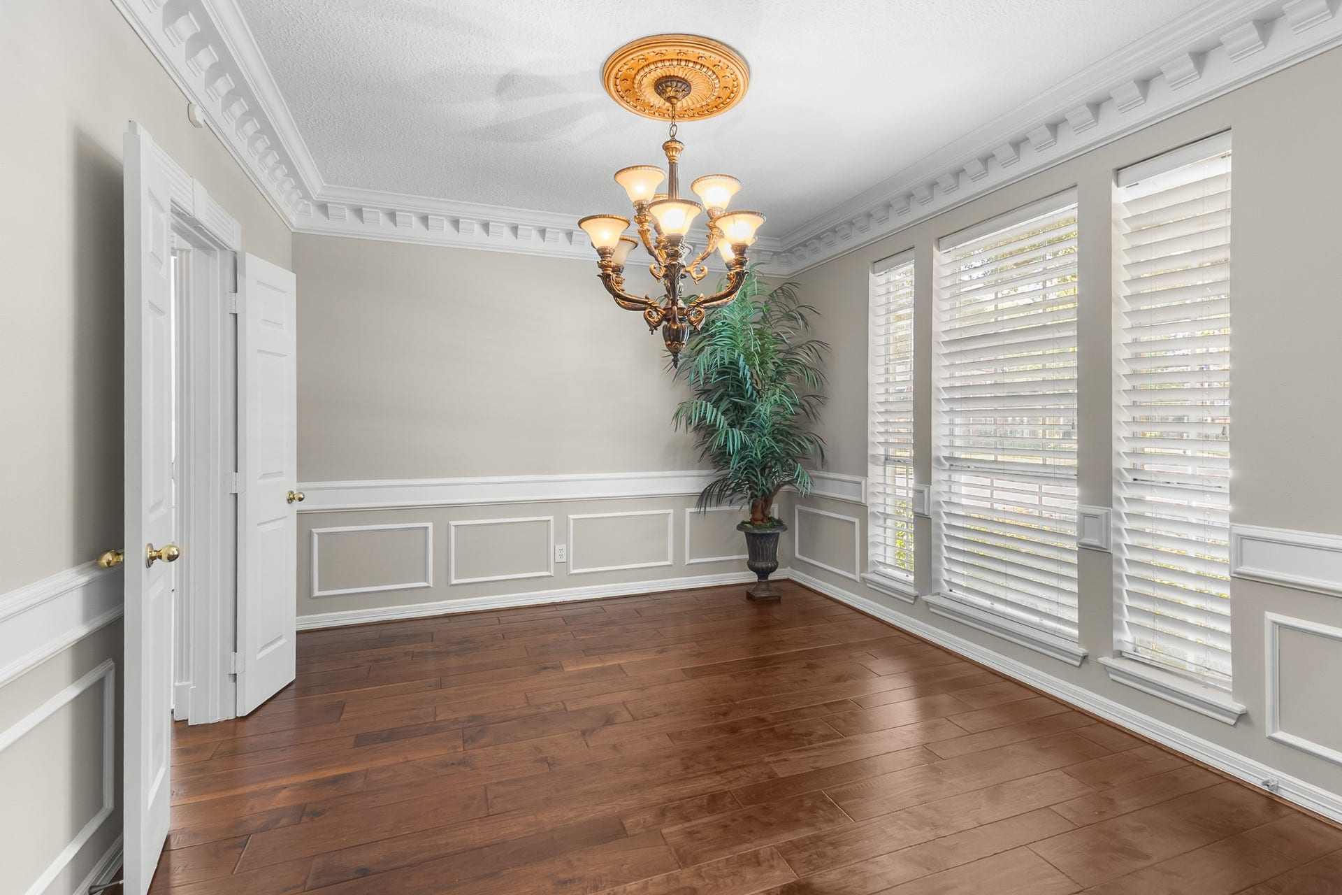 16314 Graven Hill Drive, Spring, TX 77379 Classic wainscoting, crown molding and a statement chandelier frame a gracious setting for intimate dinners and celebratory gatherings.