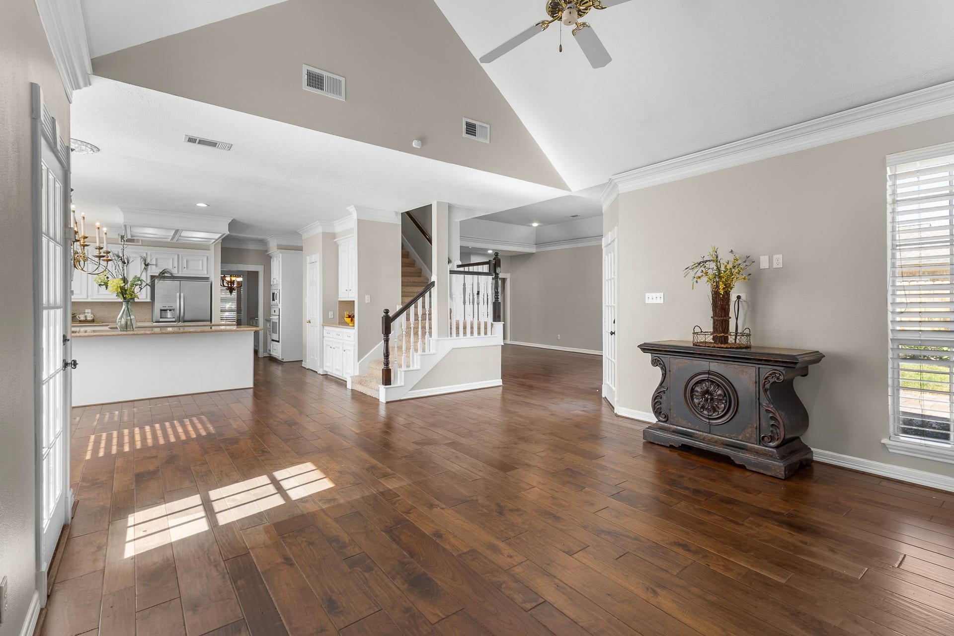 16314 Graven Hill Drive, Spring, TX 77379 Vaulted ceilings and continuous wood flooring emphasize the sense of space, while the open layout connects the family room and kitchen.