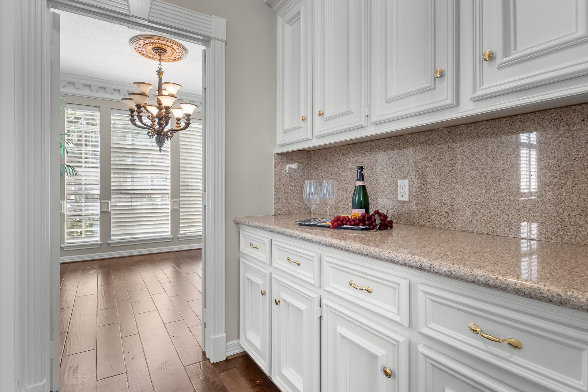 16314 Graven Hill Drive, Spring, TX 77379 A dedicated butlers pantry pairs abundant white cabinetry with warm-toned counters for convenient serving and entertaining preparation.