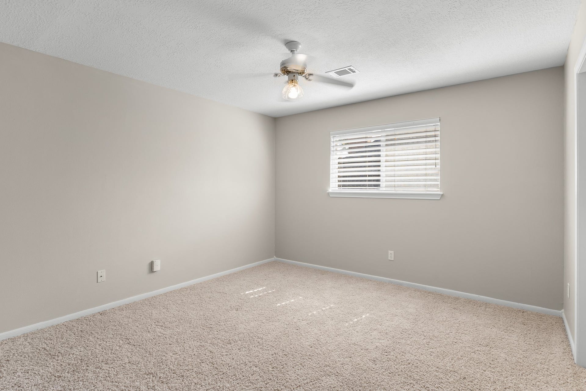 16314 Graven Hill Drive, Spring, TX 77379 A comfortable secondary bedroom offers a neutral backdrop, plush carpeting and a ceiling fan for everyday comfort.